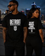 DETROIT MOVES IN SILENCE